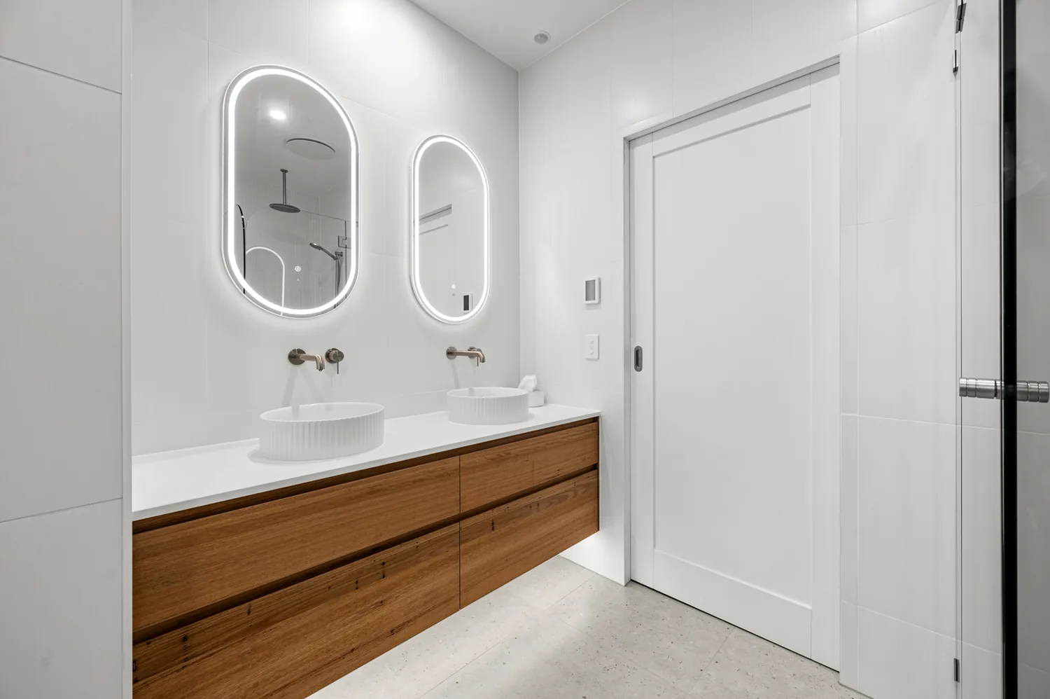 Double vanity with custom timber cabinetry and twin oval mirrors, Warrnambool