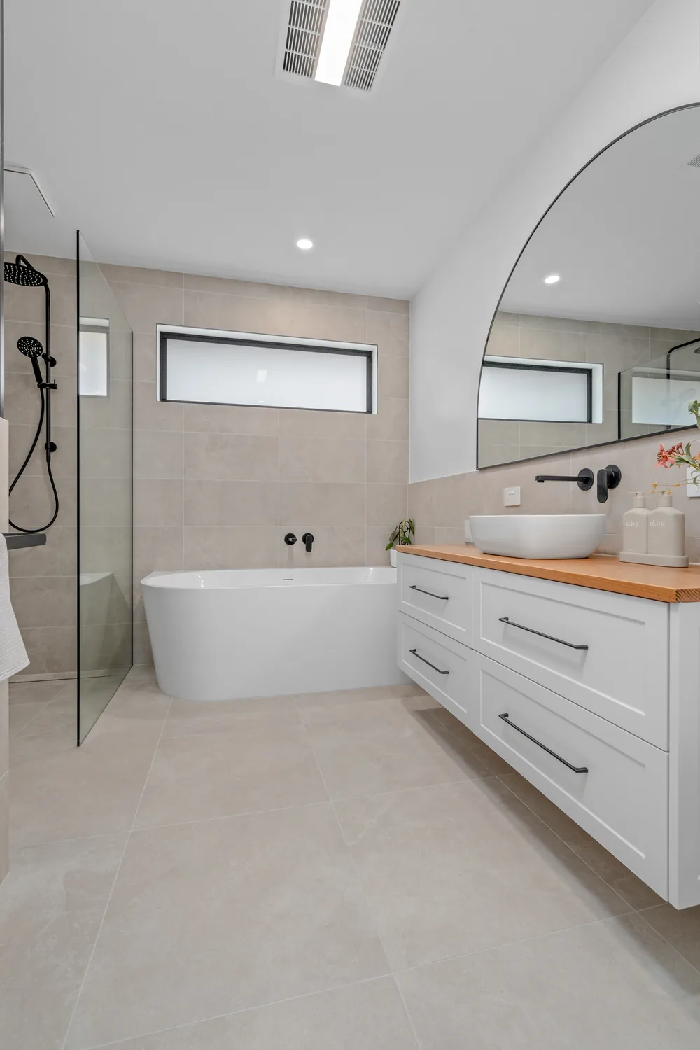 Freestanding bath with timber-top white vanity