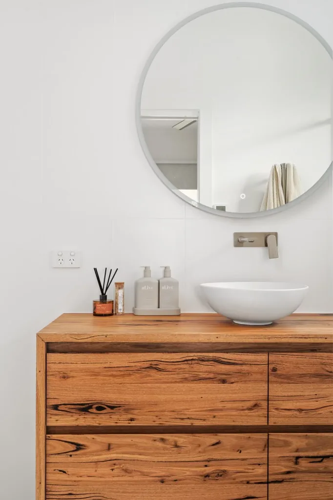 Vessel basin on timber vanity with round mirror