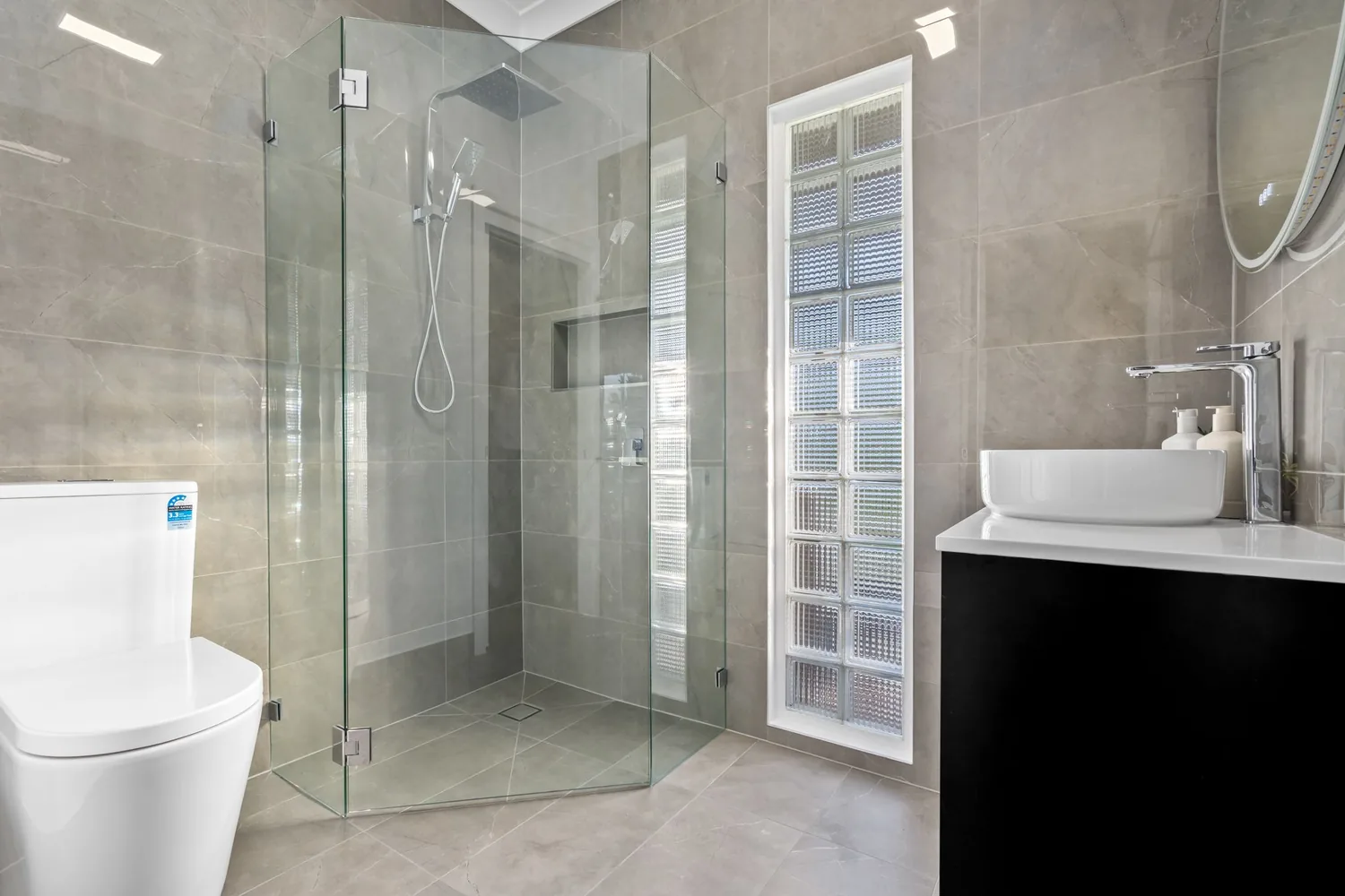 Grey tiled ensuite with vessel basin and walk-in shower