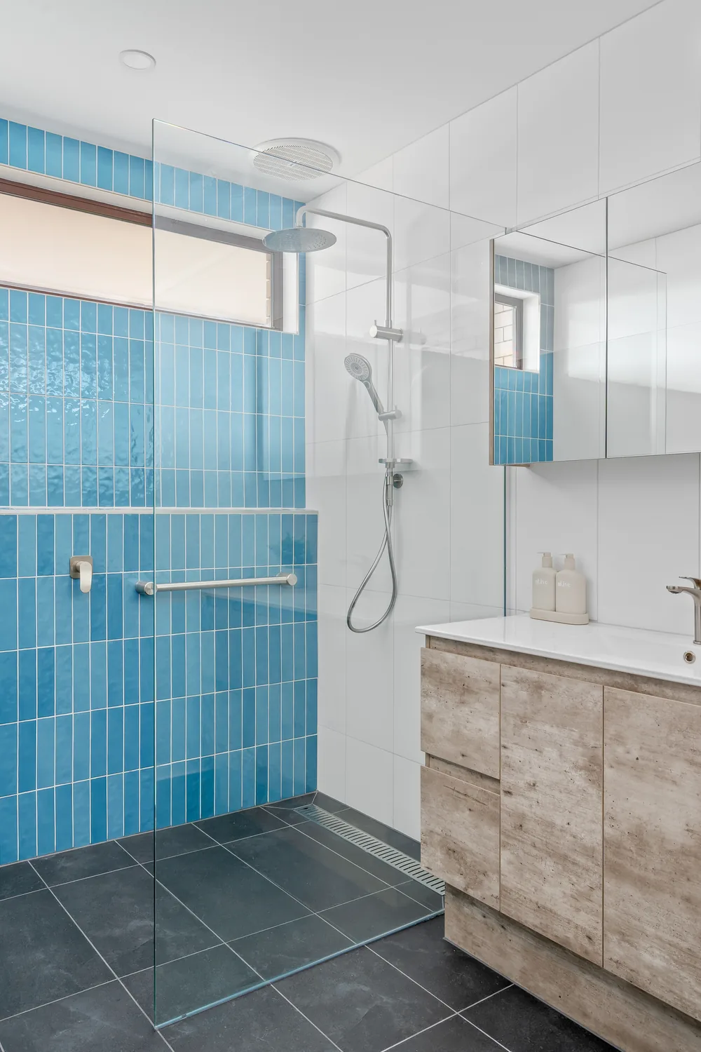 Premium ensuite renovation with timber vanity and feature tiling
